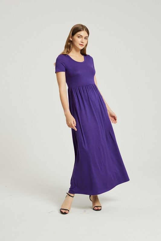 A woman elegantly poses against a plain background, wearing the vibrant Women's Summer Casual Maxi Dress With Pocket in purple, featuring short sleeves.