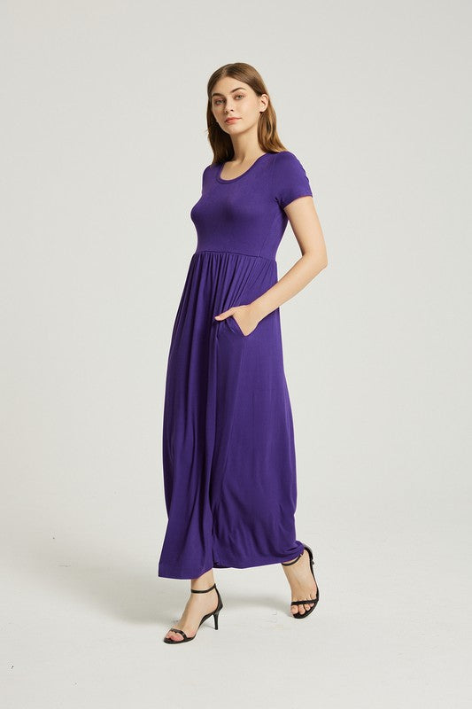 A woman elegantly poses against a plain background, wearing the vibrant Women's Summer Casual Maxi Dress With Pocket in purple, featuring short sleeves.