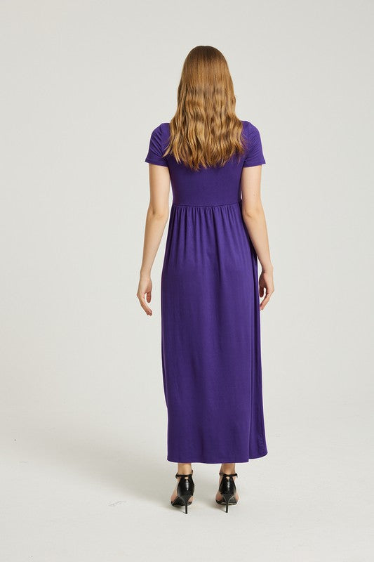 A woman elegantly poses against a plain background, wearing the vibrant Women's Summer Casual Maxi Dress With Pocket in purple, featuring short sleeves.