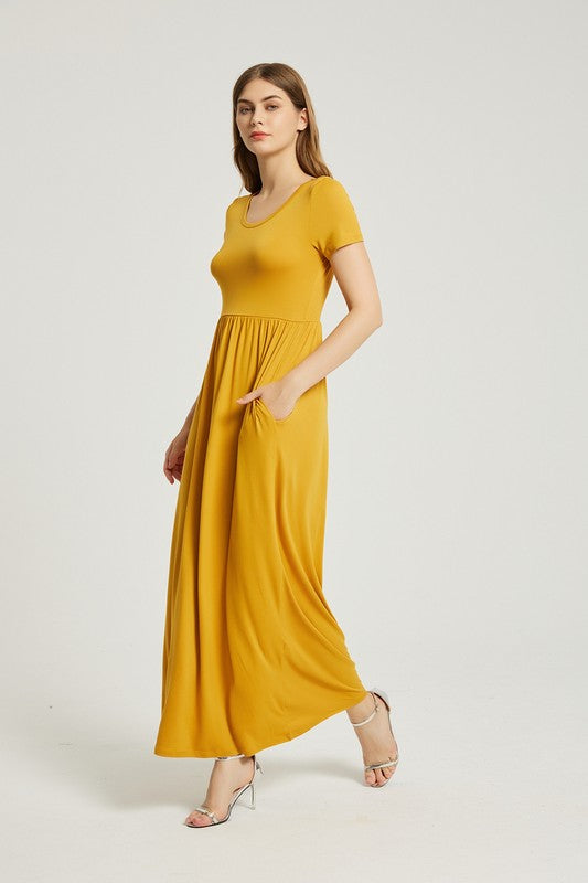 A person elegantly stands against a light gray background, wearing the Women's Summer Casual Maxi Dress With Pocket in mustard yellow, featuring short sleeves.