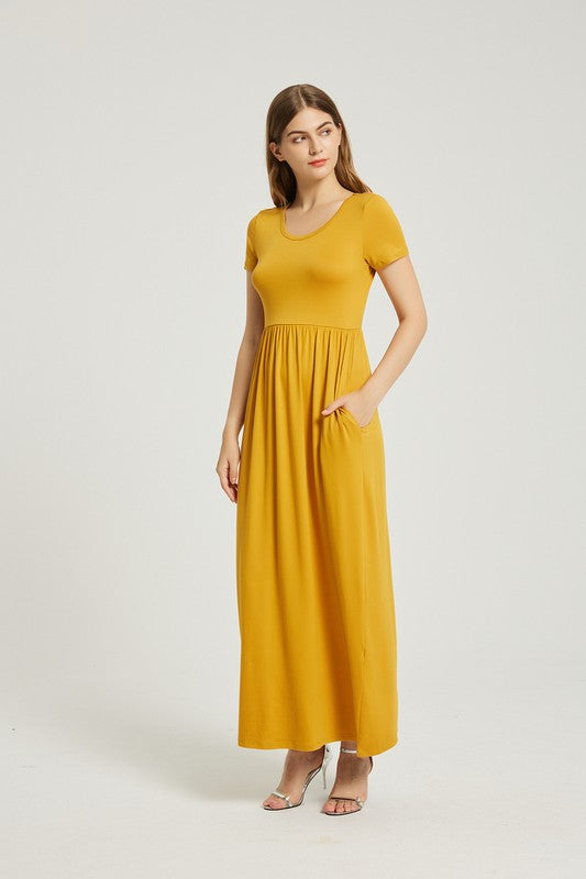 A person elegantly stands against a light gray background, wearing the Women's Summer Casual Maxi Dress With Pocket in mustard yellow, featuring short sleeves.