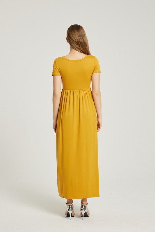 A person elegantly stands against a light gray background, wearing the Women's Summer Casual Maxi Dress With Pocket in mustard yellow, featuring short sleeves.