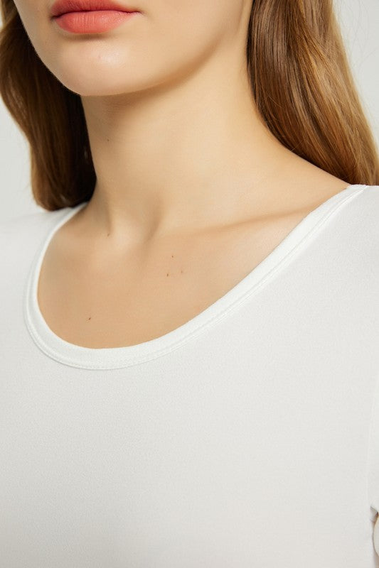 A woman in a white, short-sleeve, ankle-length Women's Summer Casual Maxi Dress With Pocket poses against a plain background. She is wearing white open-toed heels.