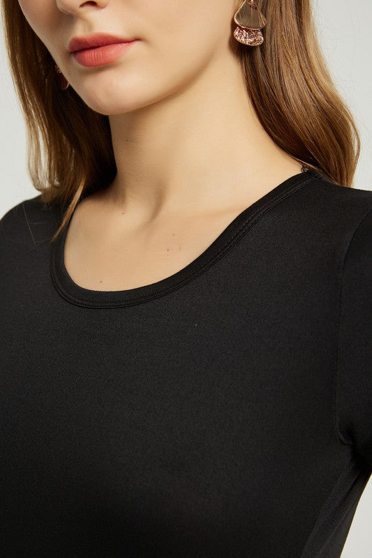 A woman stands with hands in pockets, wearing a Women's Summer Casual Floral Maxi Dress With Pocket featuring black and red floral patterns. She has long hair and is sporting black heeled sandals.