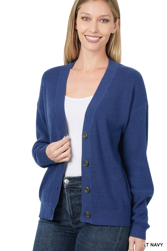 A woman is seen wearing the Viscose Sweater Cardigan in dusty blush, which features a button-front closure with dark buttons. The front and back views highlight its casual drop shoulder design. She has blonde hair and pairs the cardigan with a white top and jeans.