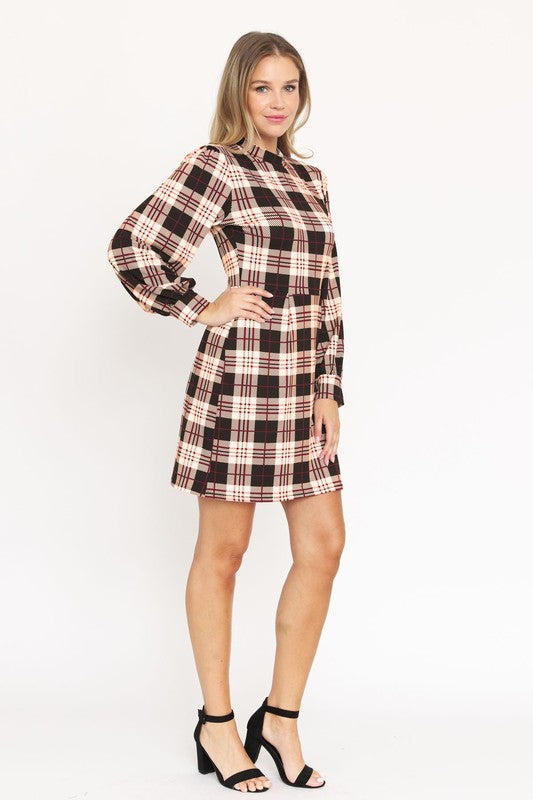 A woman stands smiling, wearing the High Neck Plaid Sheath Dress featuring a classic United States style in black, white, and red plaid with long sleeves.