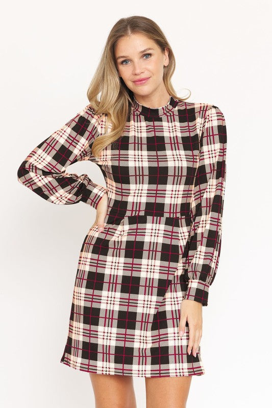 A woman stands smiling, wearing the High Neck Plaid Sheath Dress featuring a classic United States style in black, white, and red plaid with long sleeves.