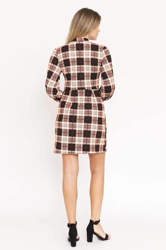 A woman stands smiling, wearing the High Neck Plaid Sheath Dress featuring a classic United States style in black, white, and red plaid with long sleeves.