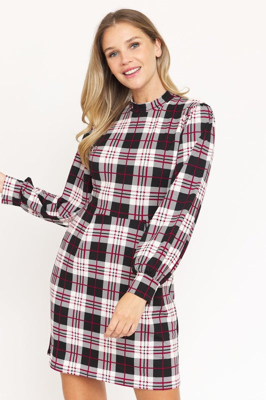 A woman stands smiling, wearing the High Neck Plaid Sheath Dress featuring a classic United States style in black, white, and red plaid with long sleeves.