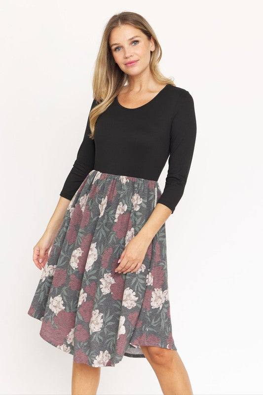 A woman in a fashionable Quarter Sleeve Midi Dress poses against a plain background, showcasing its elegant leopard print.