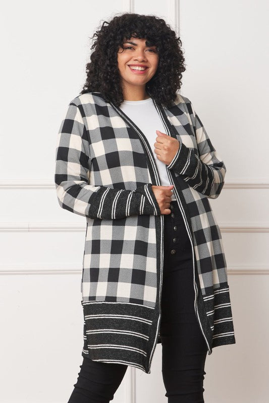 A woman wearing a Long Buffalo Plaid Stripe Trim Open Cardigan over a white top and dark jeans stands against a plain background.