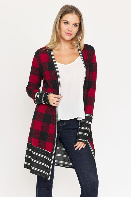 A woman wearing a Long Buffalo Plaid Stripe Trim Open Cardigan over a white top and dark jeans stands against a plain background.