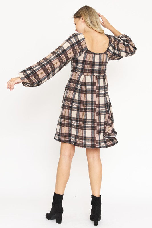 A woman in the Plaid Balloon Sleeve Midi Dress, featuring a square neckline and crafted from polyester spandex, is smiling and standing against a light background. Made in the United States.