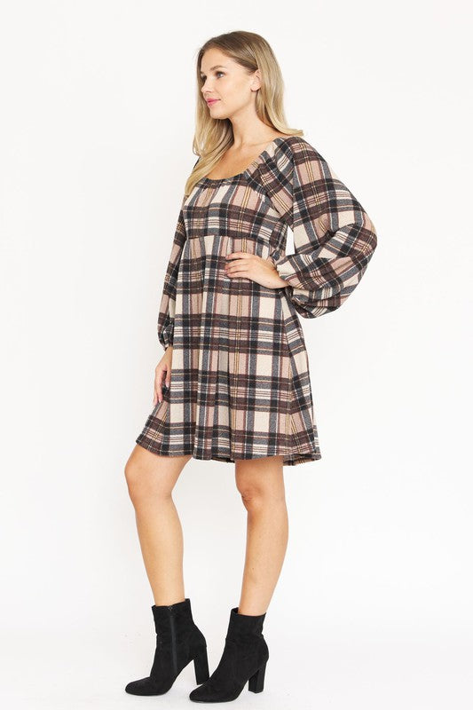 A woman in the Plaid Balloon Sleeve Midi Dress, featuring a square neckline and crafted from polyester spandex, is smiling and standing against a light background. Made in the United States.