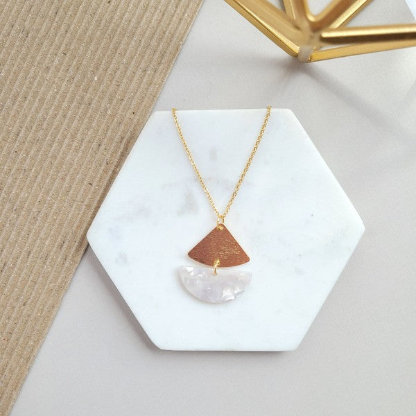 Introducing the Ava Pearl Necklace: an 18K gold-plated chain featuring a pendant with a wooden triangular segment and a white semi-circle segment, displayed on a light background. This tarnish-resistant piece is perfect for adding elegance to any outfit.