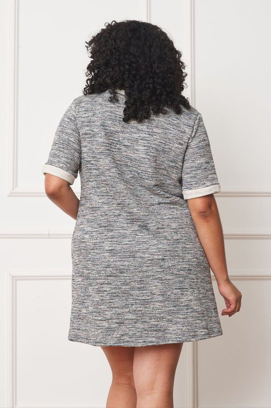 A woman with curly hair is wearing a Plus Preppy Tweed Shift Dress, featuring two front pockets and short sleeves, standing against a neutral background.