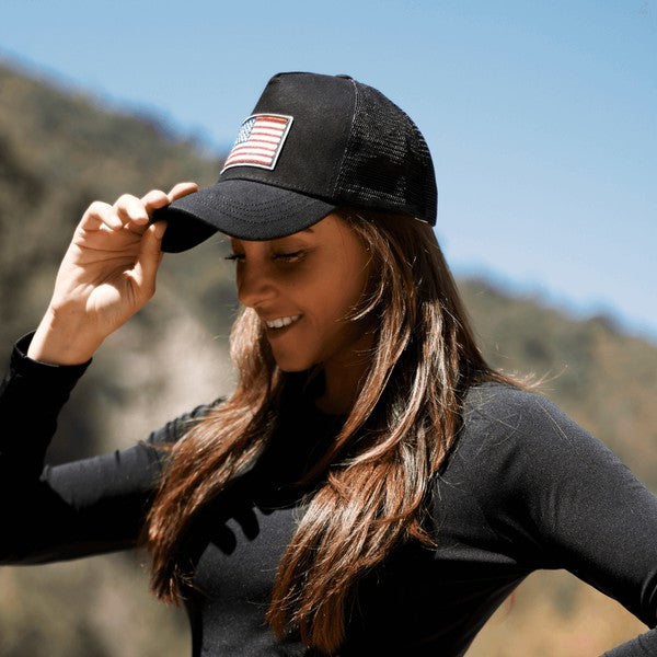 American Flag Unisex Trucker Hat with a navy blue front panel and breathable mesh back panel, perfect for outdoor activities.