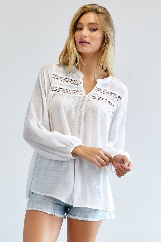 A person wearing a Solid V-Neck Blouse Top and denim shorts stands against a plain background.