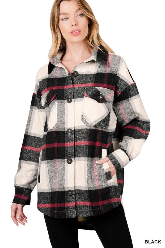 Woman wearing the Oversized Yarn Dyed Plaid Shacket featuring a checkered, camel-colored button-up design with long sleeves and chest pockets, paired with denim shorts.