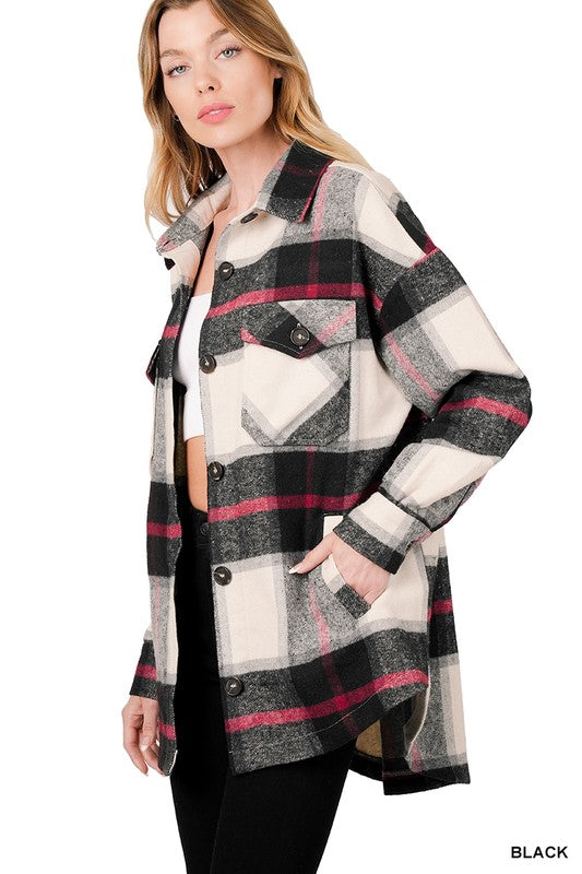 Woman wearing the Oversized Yarn Dyed Plaid Shacket featuring a checkered, camel-colored button-up design with long sleeves and chest pockets, paired with denim shorts.