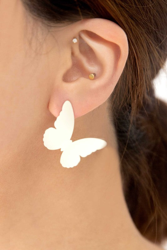 Flutter Post Earrings in a gradient from yellow to pink arranged in a diagonal line on a white background.