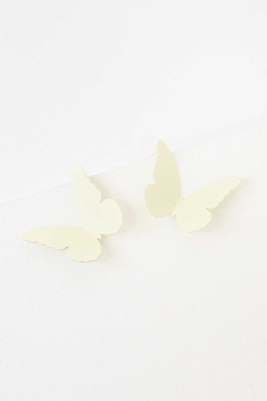 Flutter Post Earrings in a gradient from yellow to pink arranged in a diagonal line on a white background.