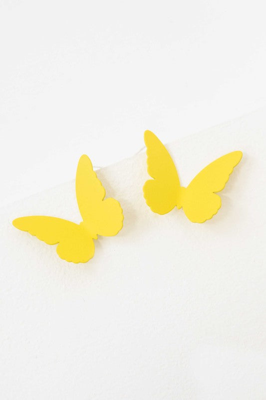 Flutter Post Earrings in a gradient from yellow to pink arranged in a diagonal line on a white background.
