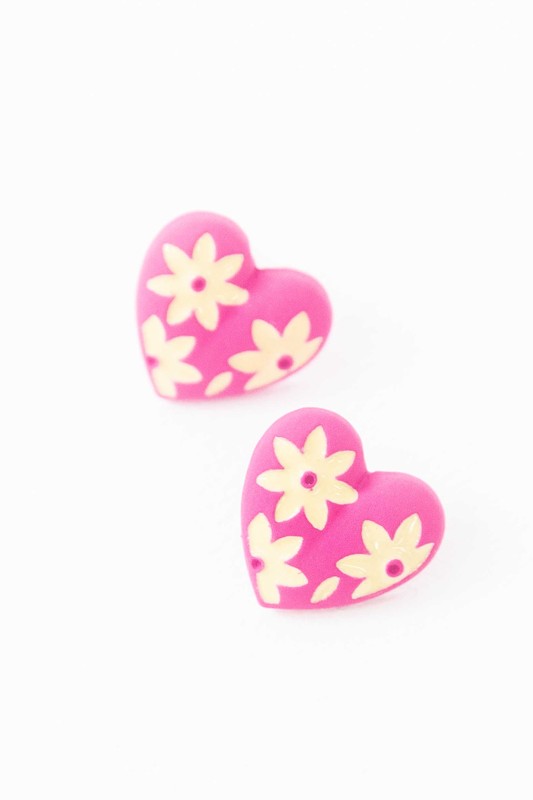 A diagonal line of Flower Lover Stud Earrings with floral patterns on a white background, featuring yellow stud hearts with Sterling Silver Posts.