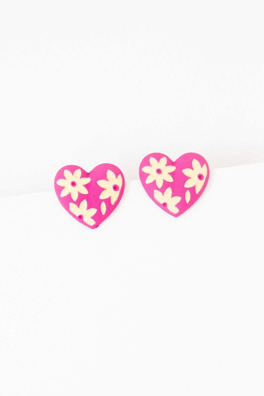 A diagonal line of Flower Lover Stud Earrings with floral patterns on a white background, featuring yellow stud hearts with Sterling Silver Posts.