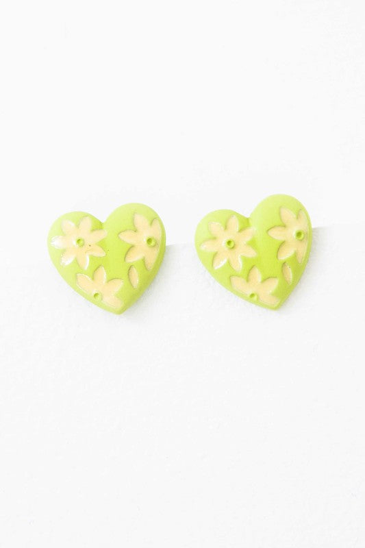 A diagonal line of Flower Lover Stud Earrings with floral patterns on a white background, featuring yellow stud hearts with Sterling Silver Posts.