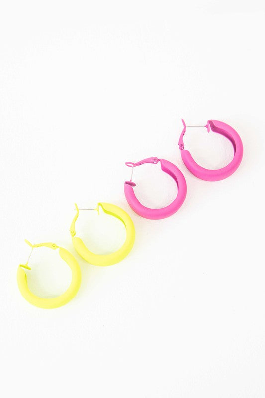 Two pairs of Eclectic Hoop Earrings, one neon pink and one yellow, against a white background.