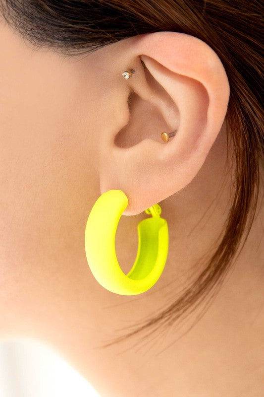 Two pairs of Eclectic Hoop Earrings, one neon pink and one yellow, against a white background.
