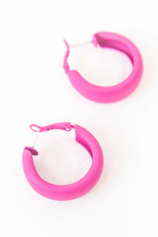Two pairs of Eclectic Hoop Earrings, one neon pink and one yellow, against a white background.