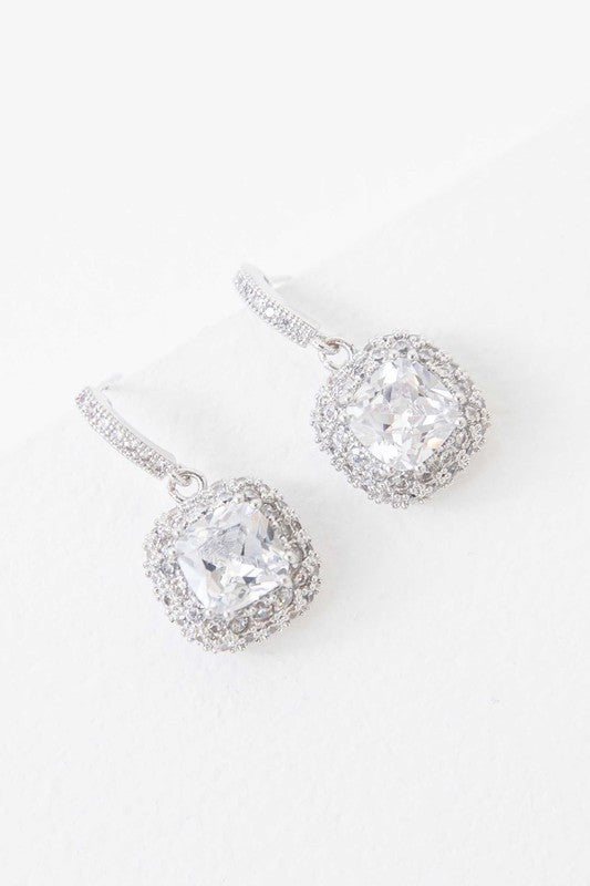 Pair of sterling silver Soigne Drop Earrings with sparkling cushion-cut and pave halo settings.