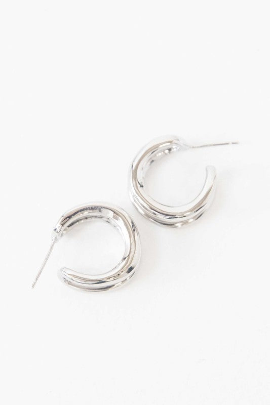 Stack of Duple Hoop Earrings on a white background.