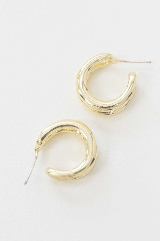 Stack of Duple Hoop Earrings on a white background.