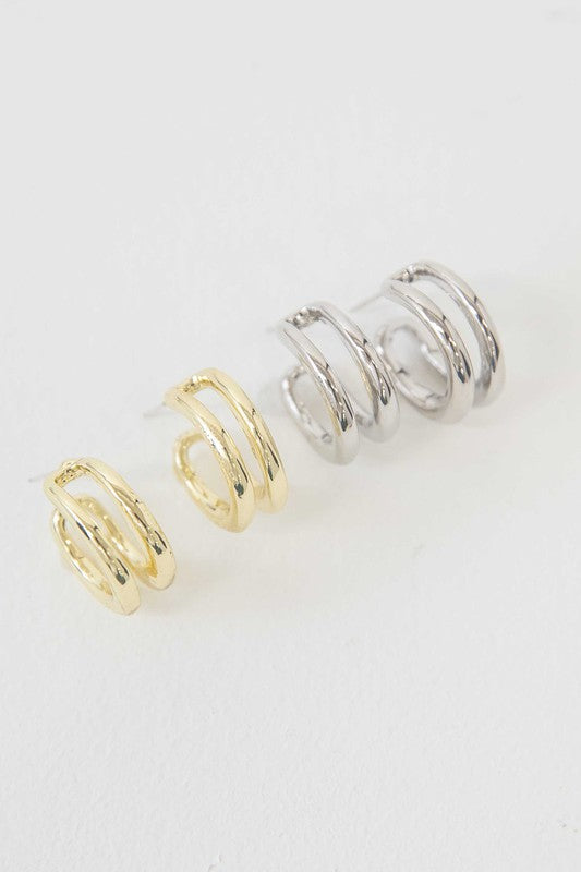 Stack of Duple Hoop Earrings on a white background.
