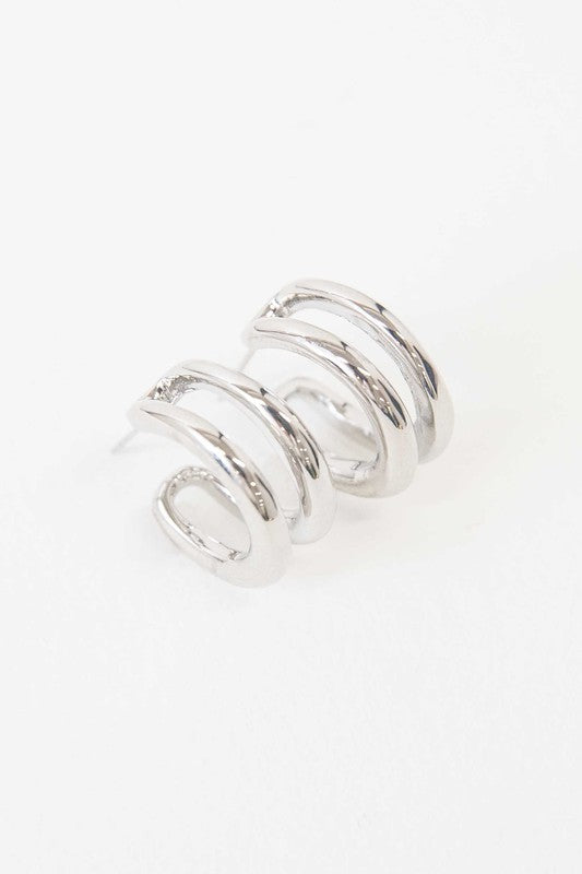 Stack of Duple Hoop Earrings on a white background.