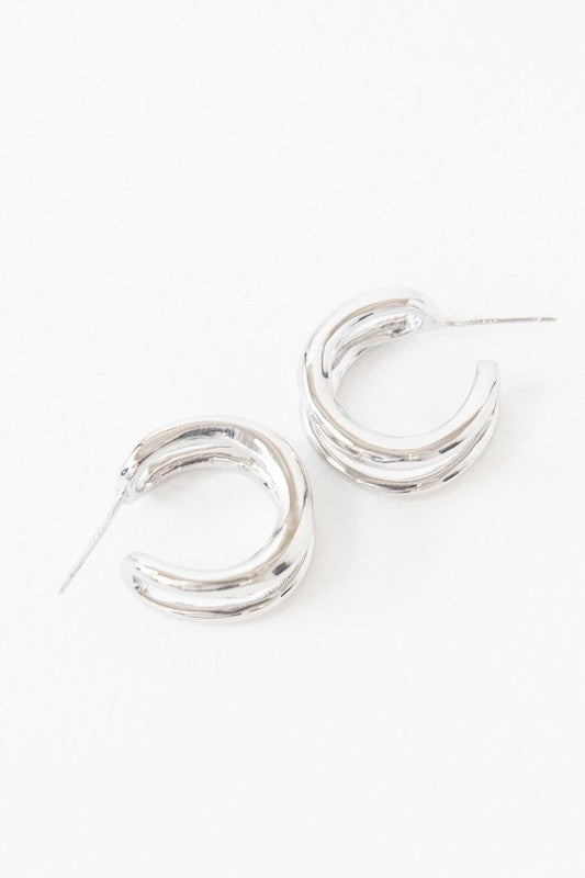 Stack of Duple Hoop Earrings on a white background.