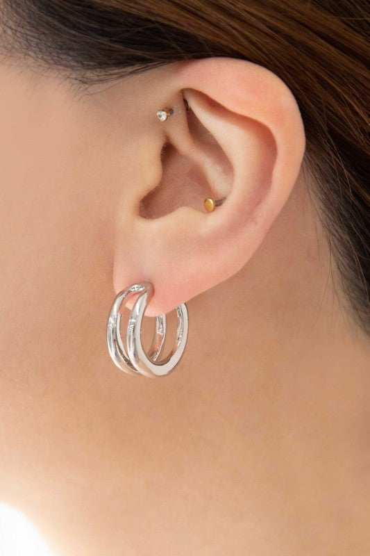 Stack of Duple Hoop Earrings on a white background.