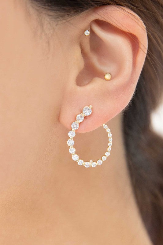 A pair of Ascension Post Earrings with embedded gemstones on a plain background.