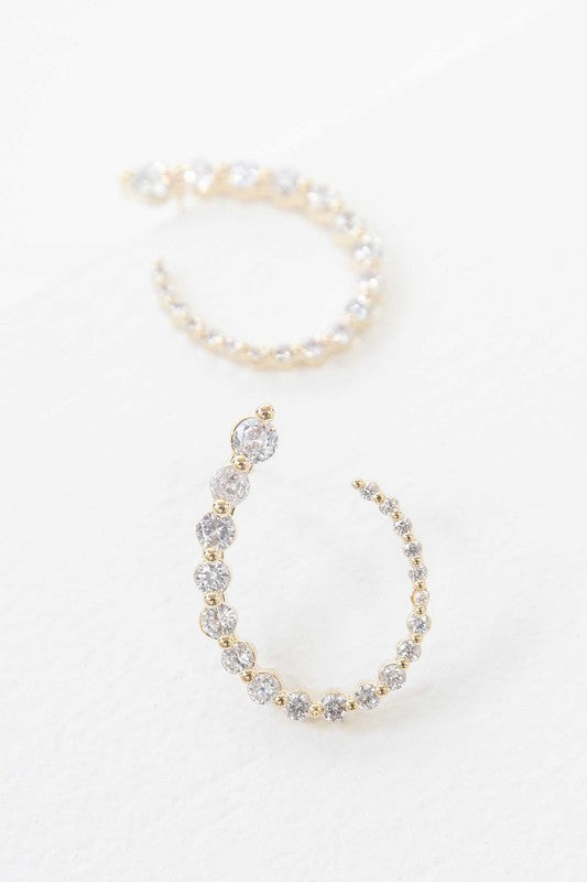 A pair of Ascension Post Earrings with embedded gemstones on a plain background.