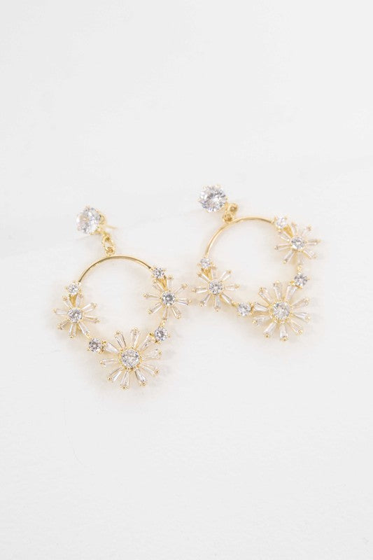 A pair of Meadow Drop Earrings with floral crystal embellishments against a white background.