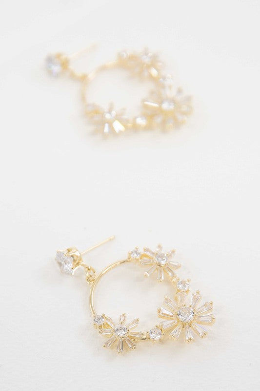 A pair of Meadow Drop Earrings with floral crystal embellishments against a white background.