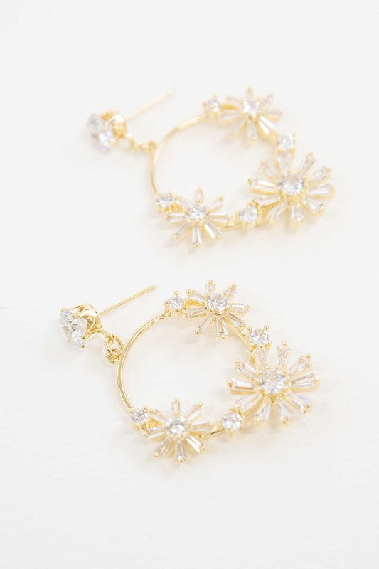 A pair of Meadow Drop Earrings with floral crystal embellishments against a white background.