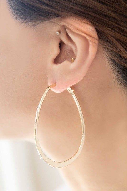 2D Shapes Asymmetrical Hoop Earrings with 14k gold plating on a white surface.
