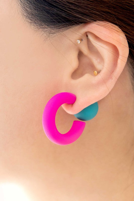 A pair of brightly colored Hula Hoop earrings with pink half-circle shapes and sterling silver posts on a white background.