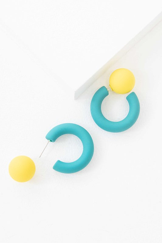 A pair of brightly colored Hula Hoop earrings with pink half-circle shapes and sterling silver posts on a white background.