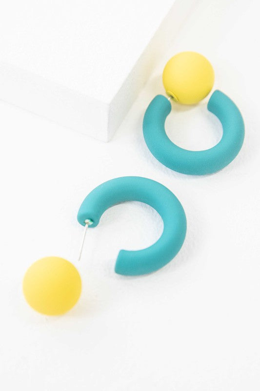 A pair of brightly colored Hula Hoop earrings with pink half-circle shapes and sterling silver posts on a white background.
