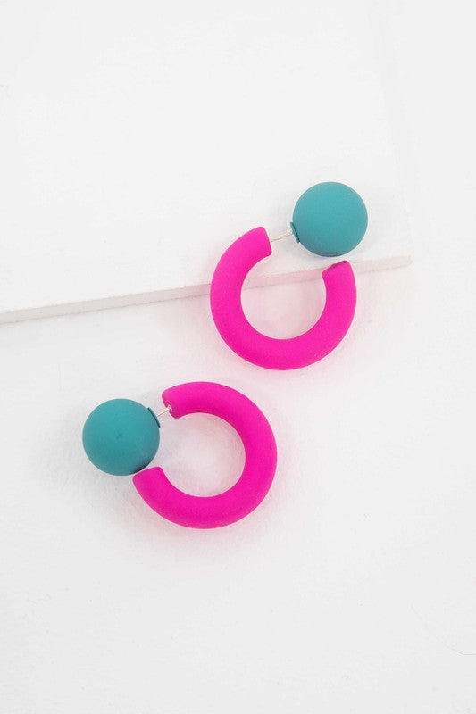 A pair of brightly colored Hula Hoop earrings with pink half-circle shapes and sterling silver posts on a white background.